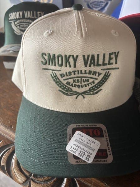 Cream and green structured cap embroidered with the Smoky Valley Distillery crest