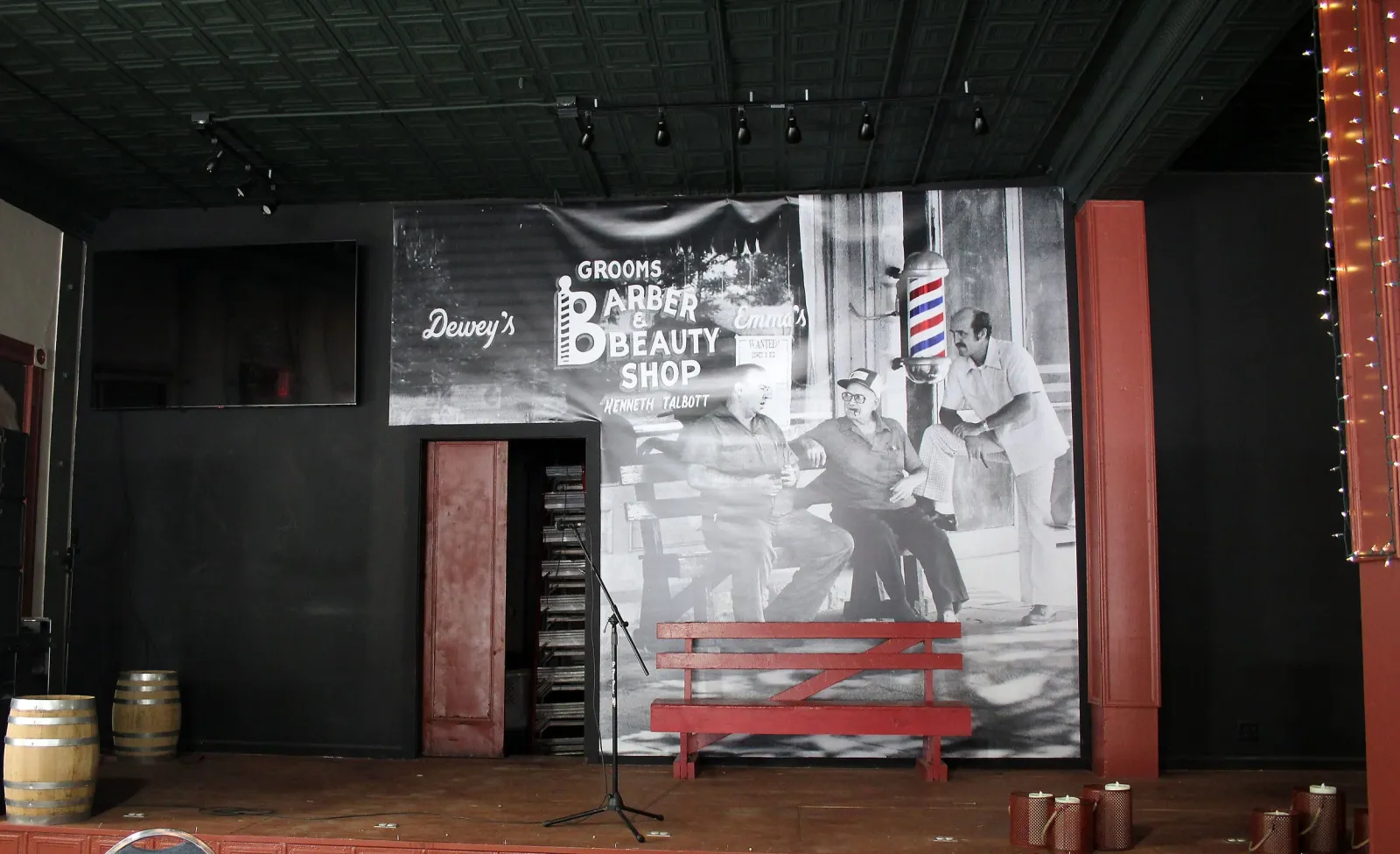 The 15 by 30 foot stage at Smoky Valley Distillery with its painted barber shop mural backdrop